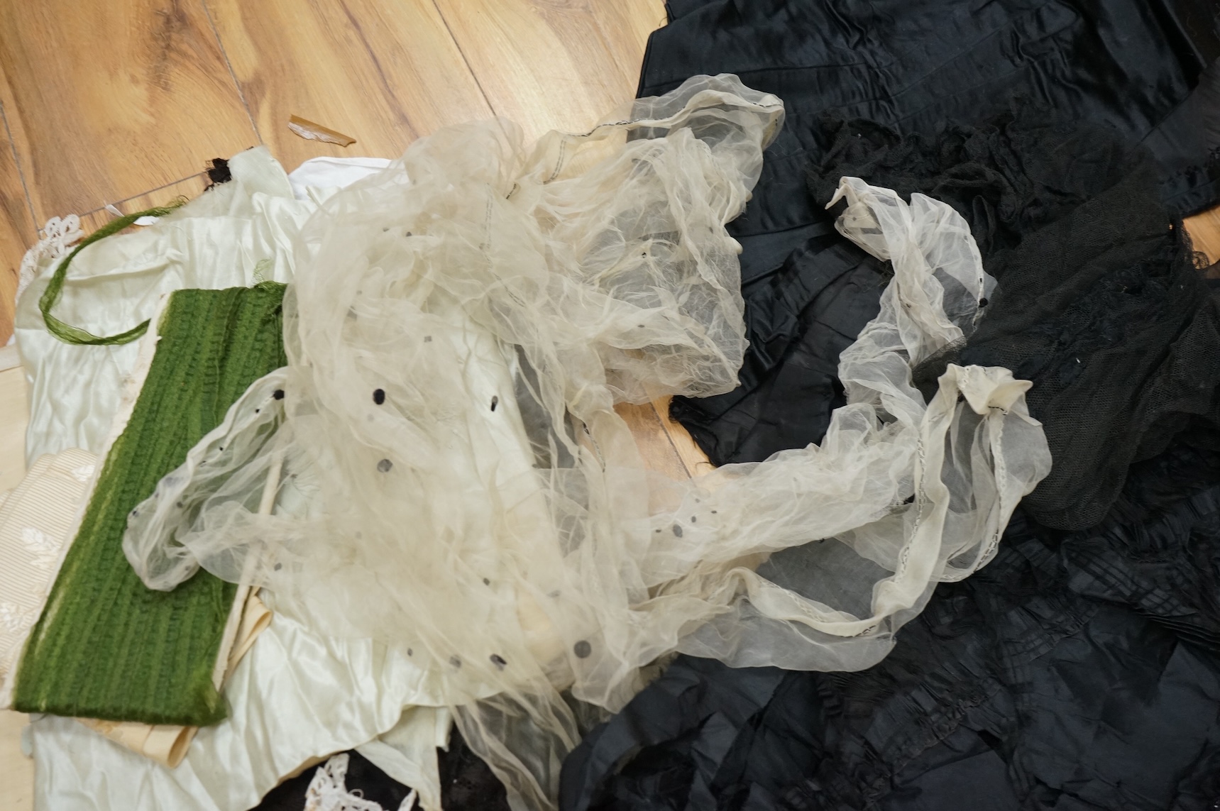 A collection of 19th century fabric and clothing, including a woven Paisley shawl, good for film and TV costume dramas